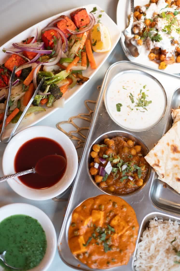 An Indian catering tray of curries and rice ready to serve